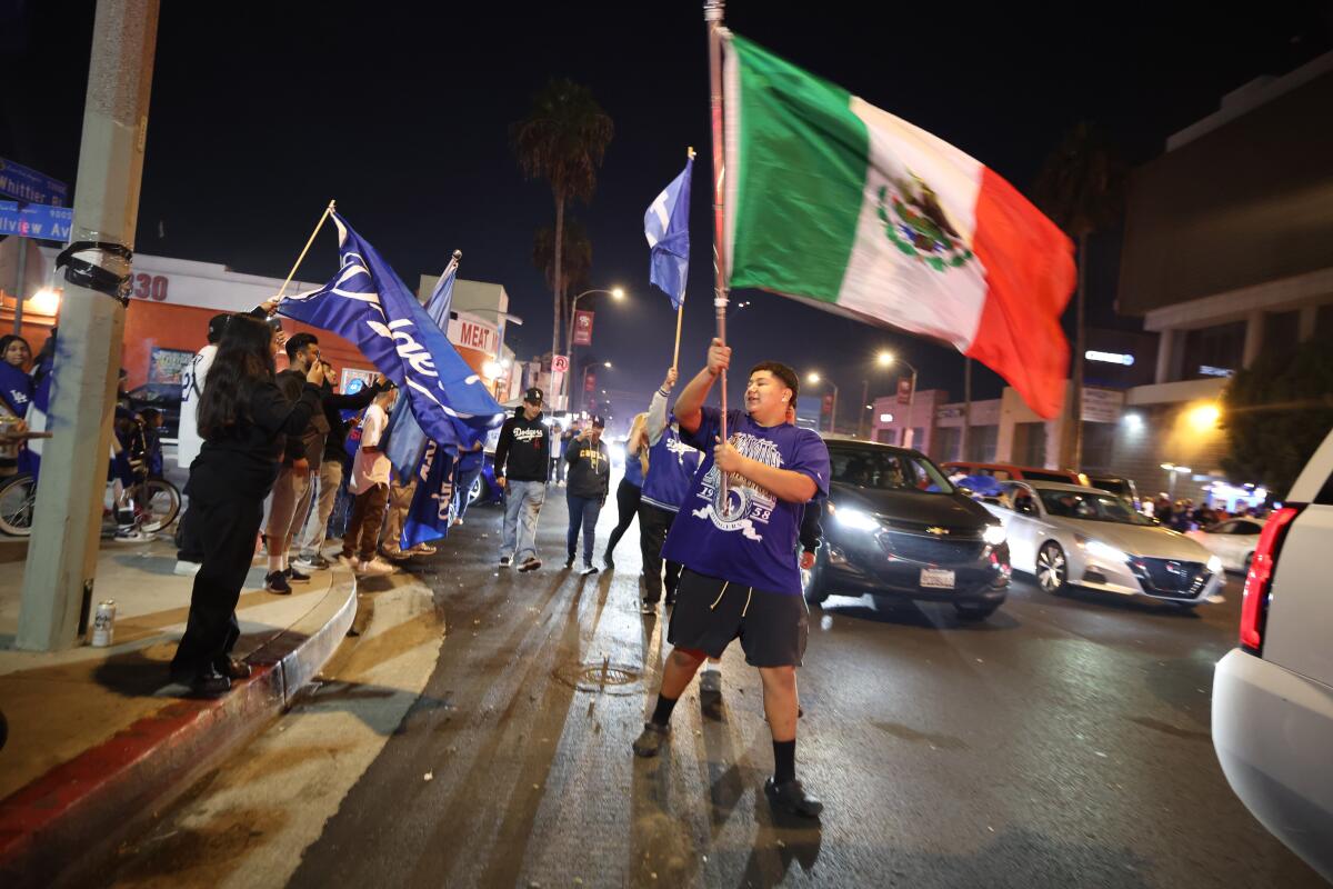 Fans on Whittier Boulevard in East Los Angeles celebrate the Dodgers’ World Series win on Wednesday night.