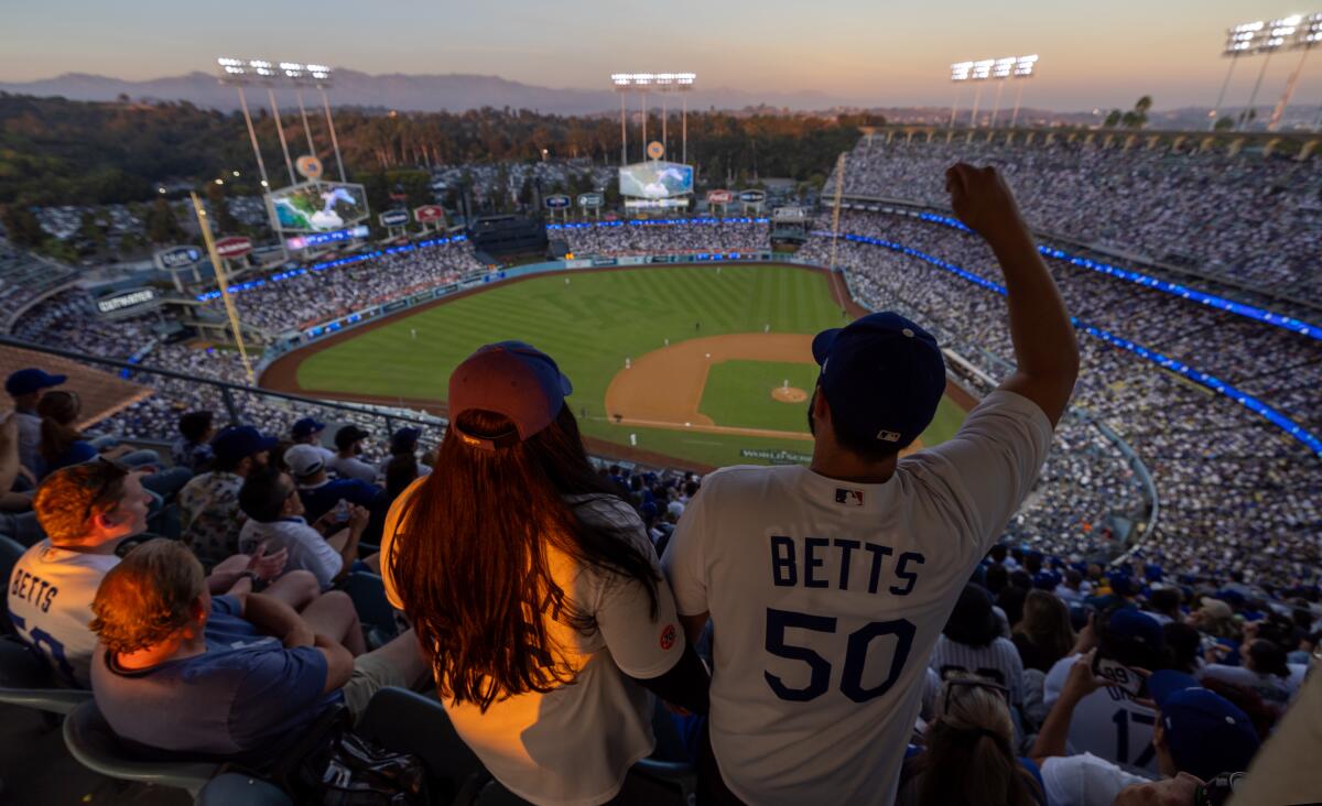 People cheer at Dodger Stadium.