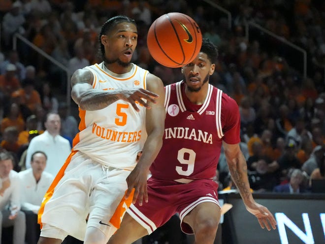 Tennessee guard Zakai Zeigler (5) passes the ball off while guarded by Indiana guard Kanaan Carlyle (9) during a college basketball exhibition game against Indiana on Sunday, October 27, 2024, in Knoxville. Tenn.