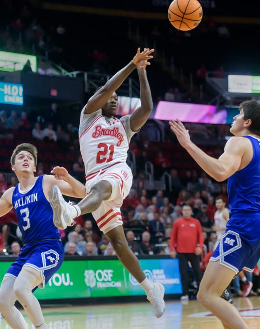 Bradley's Duke Deen passes to a teammate over the Millikin defense in the first half of their college basketball exhibition game Wednesday, Oct. 30, 2024 at the Peoria Civic Center. The Braves defeated the Big Blue 80-63.