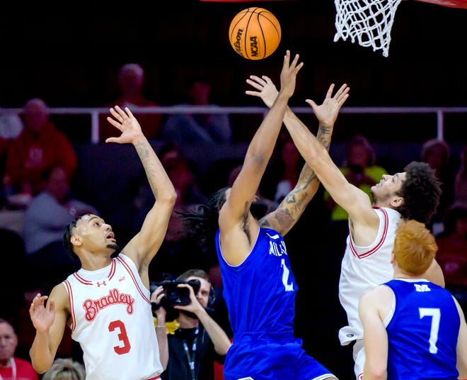 Bradley's Corey Thomas, right, blocks a shot by Millikin's Tionne Spates as teammate Zek Montgomery moves in to help in the first half of their college basketball exhibition game Wednesday, Oct. 30, 2024 at the Peoria Civic Center. The Braves defeated the Big Blue 80-63.