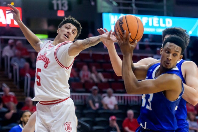 Bradley's Christian Davis tries to knock a rebound away from Millikin's Nate Straughter in the first half of their college basketball exhibition game Wednesday, Oct. 30, 2024 at the Peoria Civic Center. The Braves defeated the Big Blue 80-63.