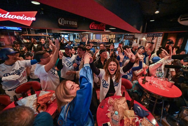 Los Angeles Dodgers fans cheer at a bar in the Shibuya district of Tokyo.