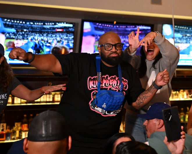 Fans at The Far Bar in Los Angeles celebrate the Dodgers winning the World Series.