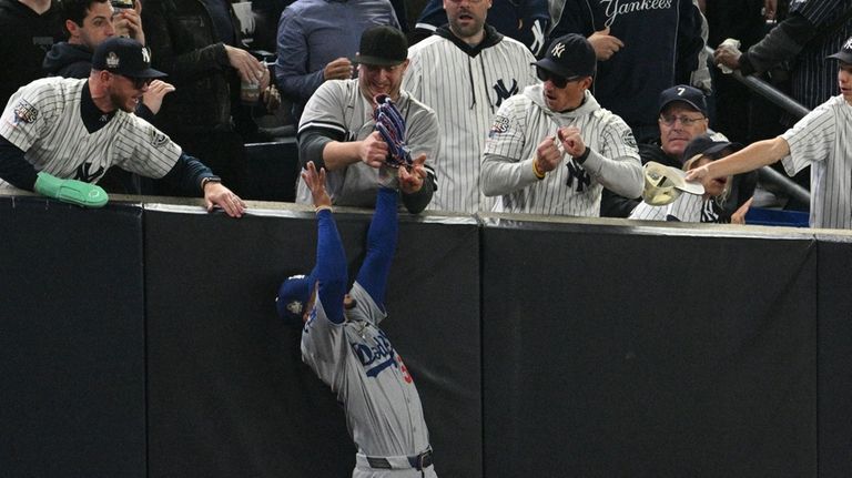 Fans interfere with a foul ball caught by Dodgers right...