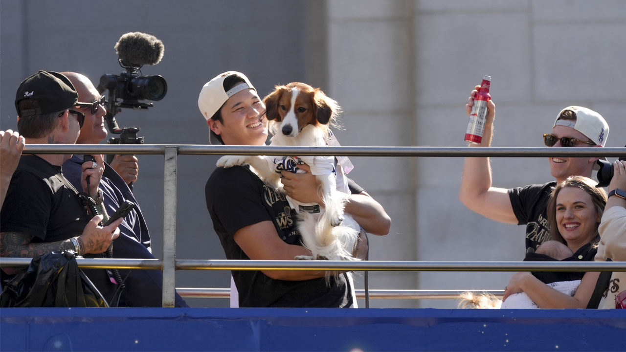 Los Angeles Dodgers' Mookie Betts waves at fans during the Los Angeles Dodgers baseball World Series championship parade Friday, Nov. 1, 2024, in Los Angeles.