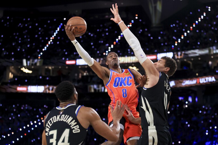 Oklahoma City Thunder forward Jalen Williams (8) shoots against Milwaukee Bucks forward Giannis Antetokounmpo (34) and center Brook Lopez (11) during the first half of the championship game in the NBA Cup basketball tournament Tuesday, Dec. 17, 2024, in Las Vegas. (AP Photo/Ian Maule)