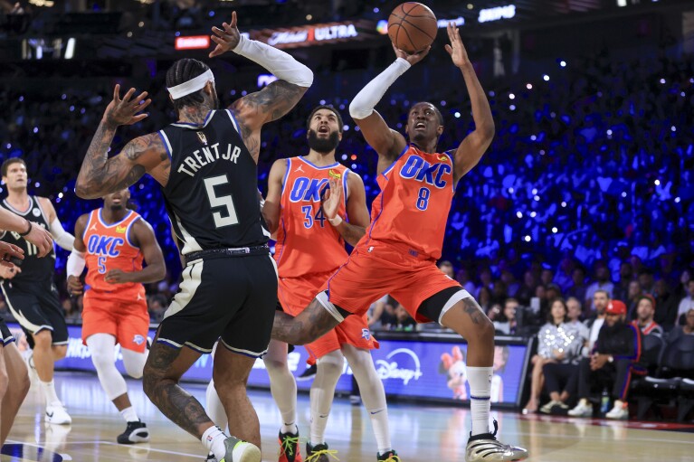 Oklahoma City Thunder forward Jalen Williams (8) shoots against Milwaukee Bucks guard Gary Trent Jr. (5) during the first half of the championship game in the NBA Cup basketball tournament Tuesday, Dec. 17, 2024, in Las Vegas. (AP Photo/Ian Maule)