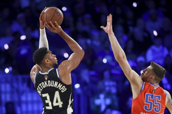 Milwaukee Bucks forward Giannis Antetokounmpo (34) shoots over Oklahoma City Thunder center Isaiah Hartenstein (55) during the first half of the championship game in the NBA Cup basketball tournament Tuesday, Dec. 17, 2024, in Las Vegas. (AP Photo/Ian Maule)