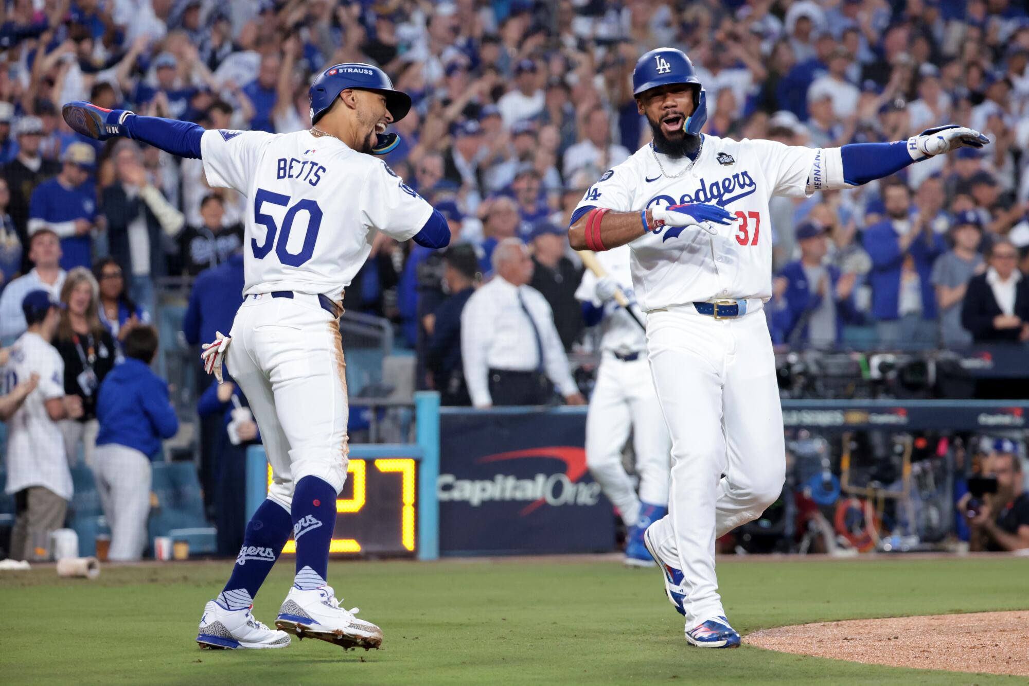 Teoscar Hernández, right, celebrates with Mookie Betts after hitting a two-run home run in Game 2 of the World Series.