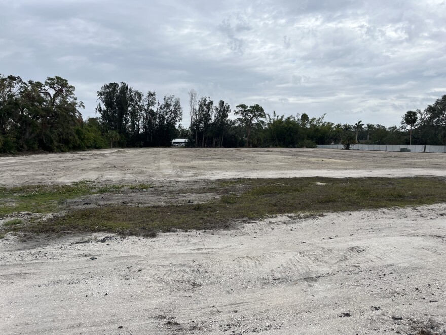 An empty plot with grass and gravel