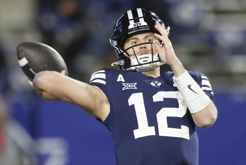 PROVO, UT - NOVEMBER 30:  Jake Retzlaff #12 of the Brigham Young Cougars throws a pass during warmups before their game against the Houston Cougars at LaVell Edwards Stadium on November 30, 2024 in Provo, Utah. (Photo by Chris Gardner/Getty Images)