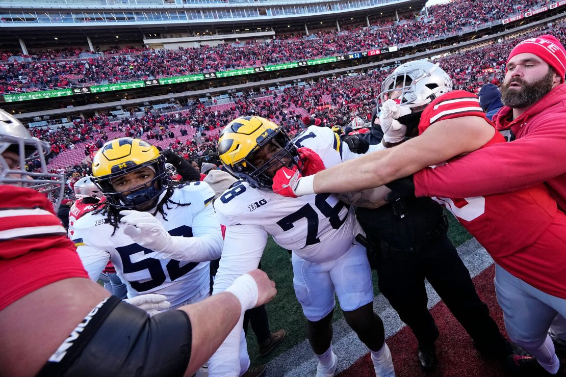 Michigan Wolverines and Ohio State Buckeyes fight following the NCAA football game at Ohio Stadium in Columbus.