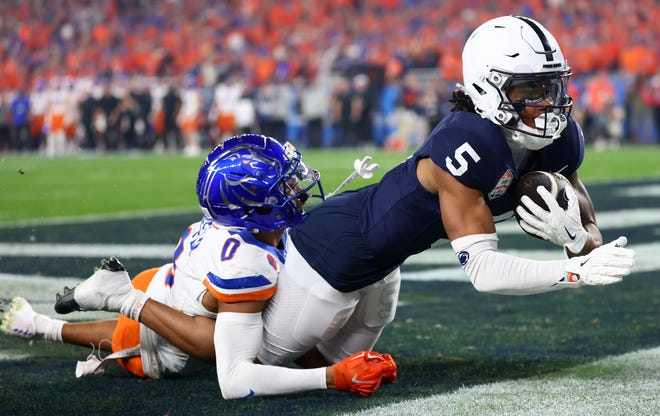 Penn State wide receiver Omari Evans (5) makes a touchdown catch over Boise State safety Ty Benefield (0) during the first half of the Fiesta Bowl.