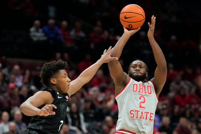 Ohio State guard Bruce Thornton (2) shoots over Michigan State guard Gehrig Normand, left, in the first half of an NCAA college basketball game Friday, Jan. 3, 2025, in Columbus, Ohio.