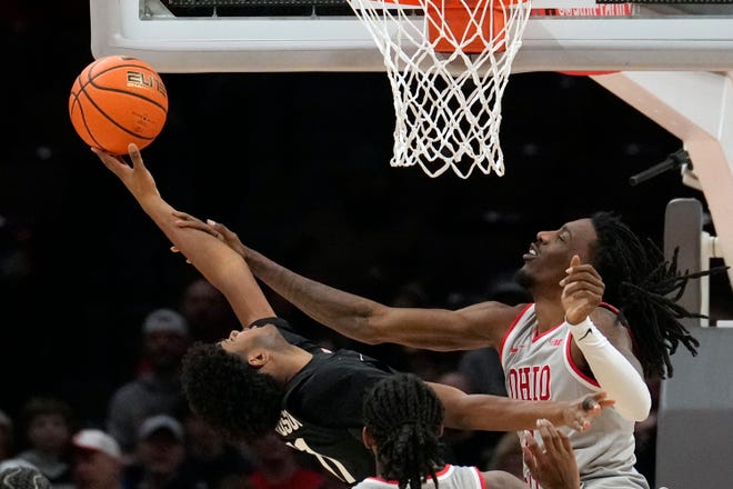 Michigan State guard Jase Richardson, left, shoots as Ohio State forward Aaron Bradshaw, right, defends in the first half of an NCAA college basketball game Friday, Jan. 3, 2025, in Columbus, Ohio.