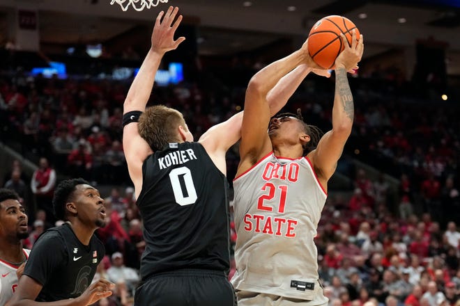 Ohio State forward Devin Royal (21) is fouled by Michigan State forward Jaxon Kohler (0) as he shoots in the first half of an NCAA college basketball game Friday, Jan. 3, 2025, in Columbus, Ohio.