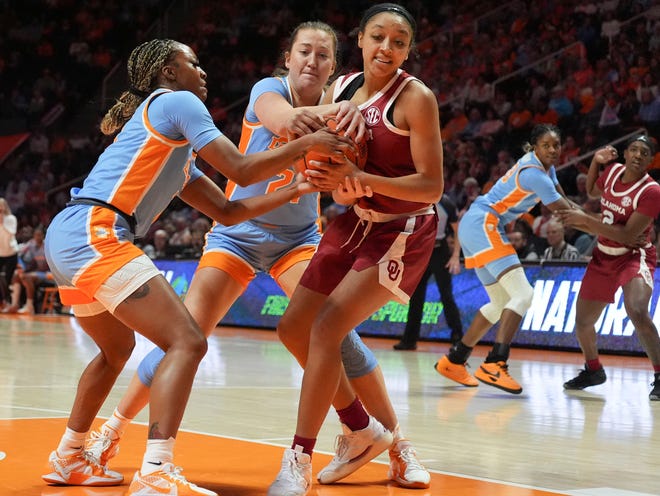 Oklahoma's Zya Vann (3) tries to protect the ball from Tennessee's Samara Spencer (7) and Tess Darby (21) during an NCAA college basketball game on Sunday, Jan. 5, 2025 in Knoxville, Tenn.