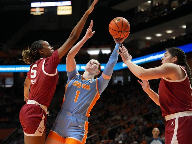 Tennessee's Sara Puckett (1) tries to score while guarded by Oklahoma's Kiersten Johnson (5) and Payton Verhulst (12) during an NCAA college basketball game on Sunday, Jan. 5, 2025 in Knoxville, Tenn.