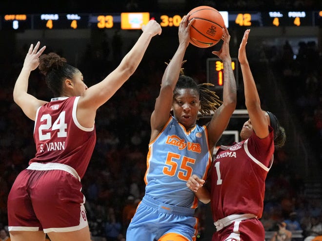 Tennessee's Talaysia Cooper (55) tries to get past Oklahoma's Skylar Vann (24) and Nevaeh Tot (1) during an NCAA college basketball game on Sunday, Jan. 5, 2025 in Knoxville, Tenn.