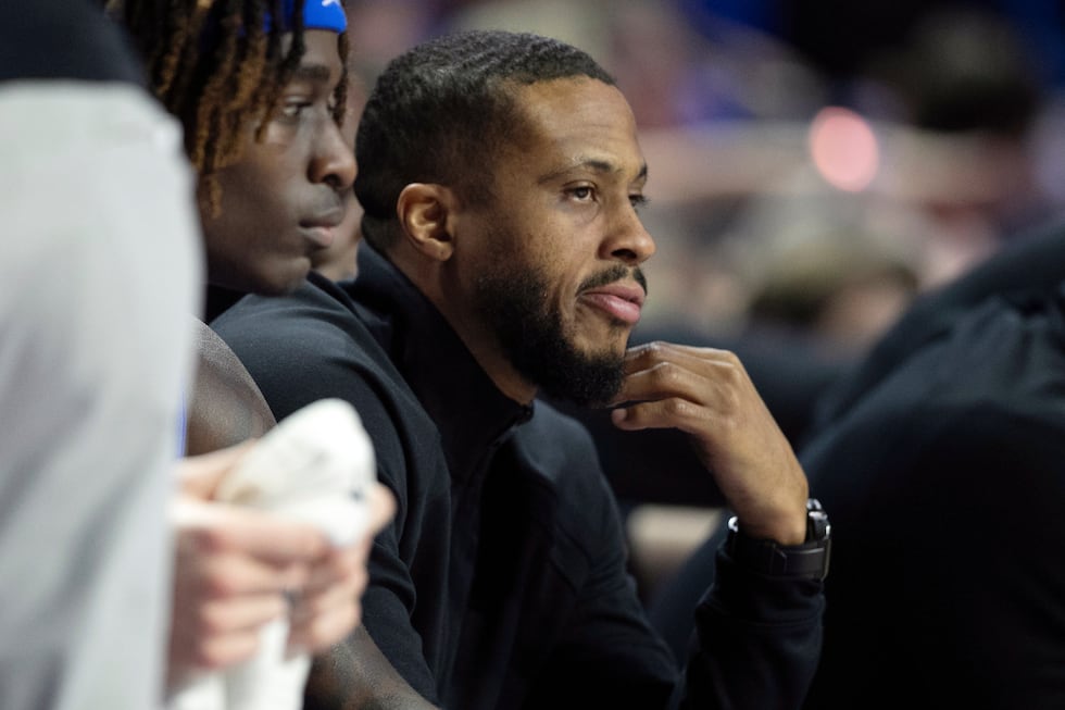 Florida assistant coach Taurean Green eyes the action during the first half of an NCAA college...