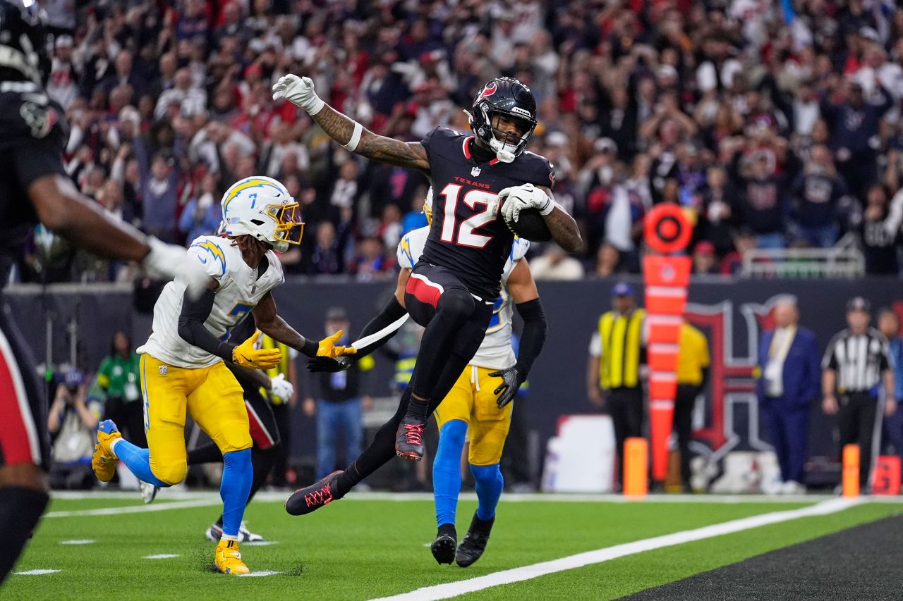 Houston Texans wide receiver Nico Collins leaps into the end zone for a touchdown during the playoff game against the Los Angeles Chargers on Saturday, January 11 in Houston.