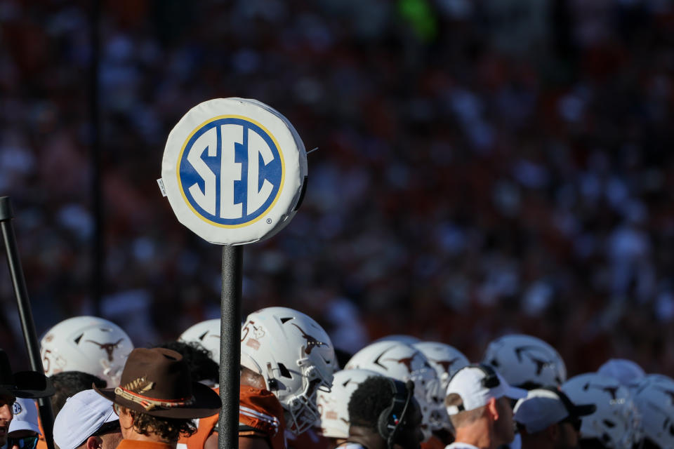 AUSTIN, TX - NOVEMBER 23: The SEC logo is on top of a yardage marker as Texas Longhorn helmets are in the background during the SEC college football game between Texas Longhorns and Kentucky Wildcats on November 23, 2024, at Darrell K Royal - Texas Memorial Stadium in Austin, TX. (Photo by David Buono/Icon Sportswire via Getty Images)