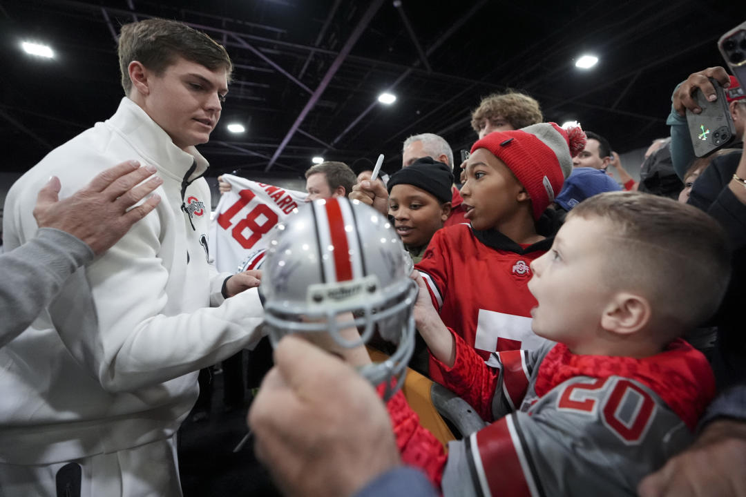 Ohio State quarterback Will Howard signs autographs during media day ahead of the national championship NCAA College Football Playoff game between Ohio State and Notre Dame Saturday, Jan. 18, 2025, in Atlanta. The game will be played on Monday. (AP Photo/Brynn Anderson)