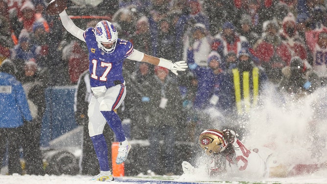 Josh Allen of the Buffalo Bills scores a touchdown as Fred Warner of the San Francisco 49ers defends during the second half of an NFL football game at Highmark Stadium on December 1, 2024 in Orchard Park, New York.