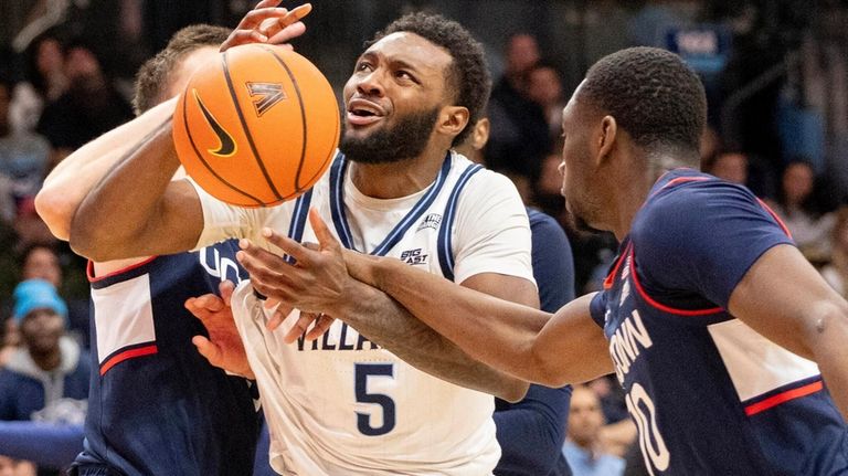 Villanova guard Wooga Poplar (5) is fouled by Connecticut guard...