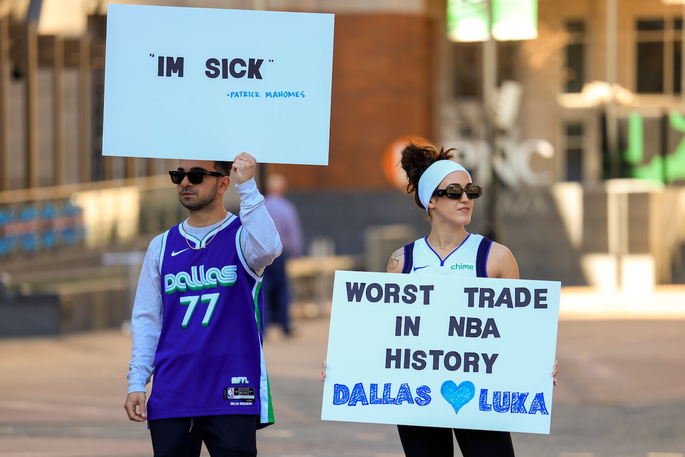 Ryan Safdarinia (left) and Lillian McCall hold signs reacting to the news that the Dallas...