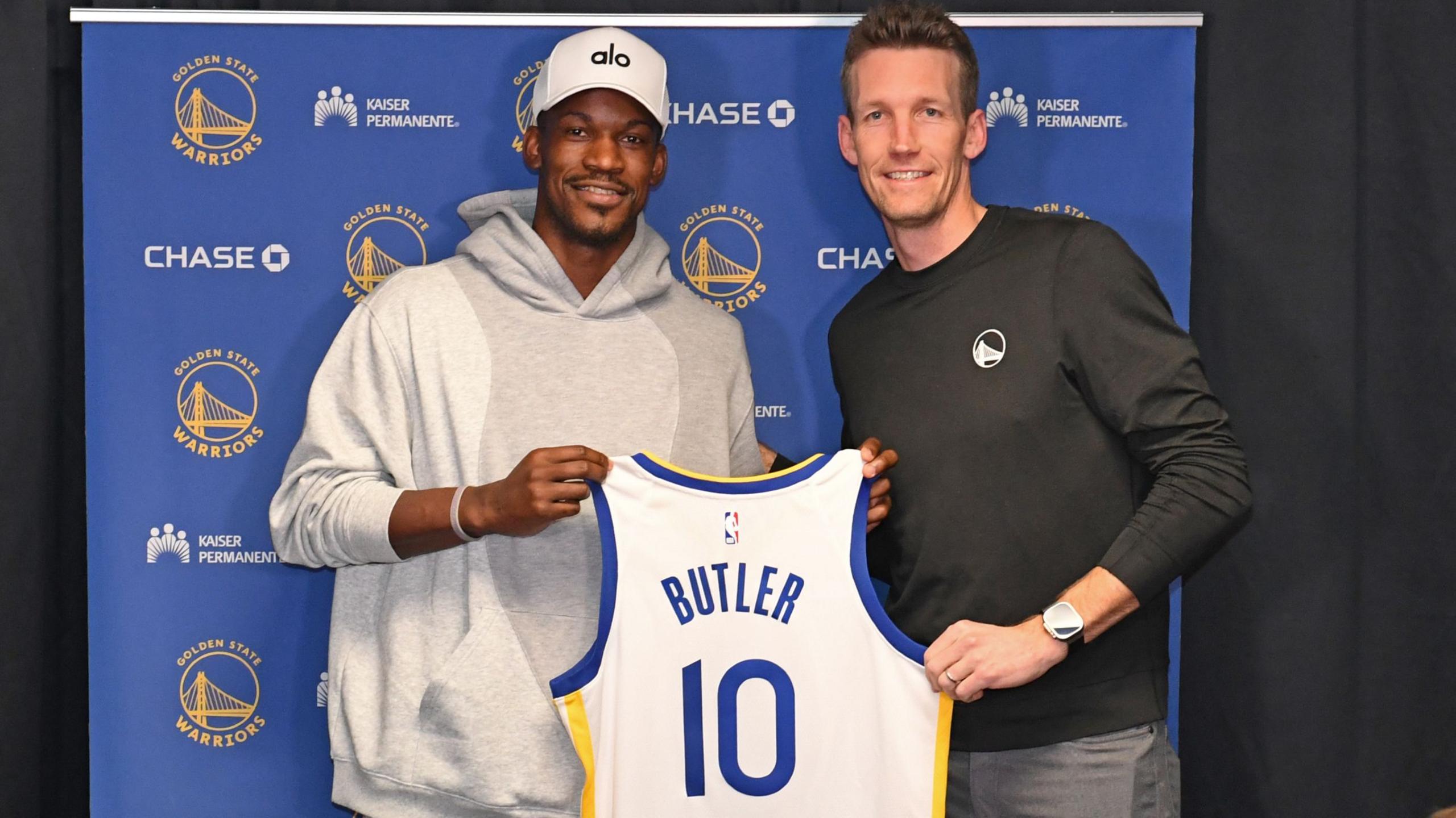 Jimmy Butler #10 of the Golden State Warriors poses for a photo with Michael Joseph Dunleavy Jr. during a press conference before the game against the Los Angeles Lakers
