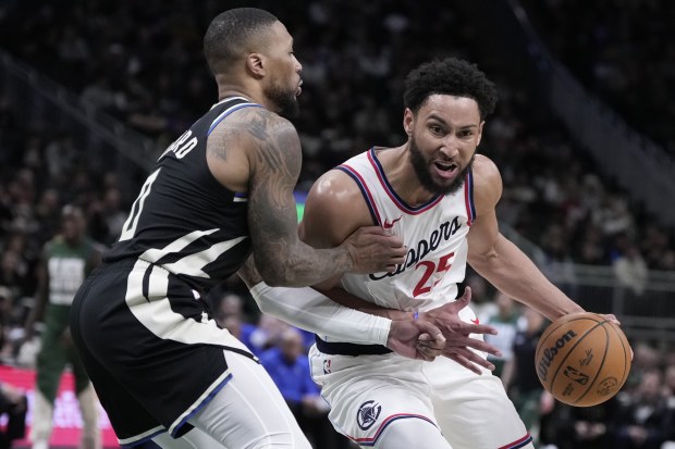 The Los Angeles Clippers' Ben Simmons tries to get past the Milwaukee Bucks' Damian Lillard.