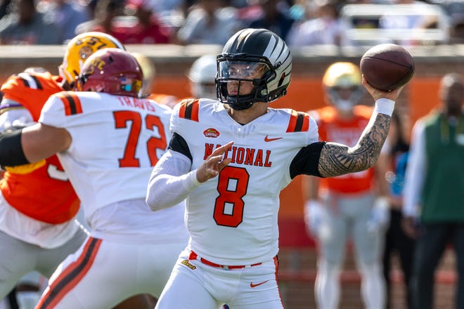 National team quarterback Dillon Gabriel of Oregon (8) throws the ball against the American team during the first half at Hancock Whitney Stadium.