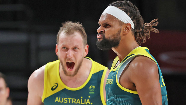 Patty Mills #5 and Joe Ingles #7 of Team Australia react against Team Slovenia 