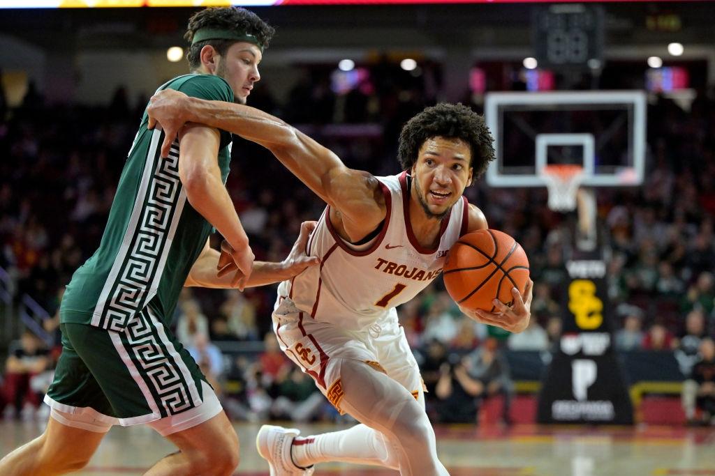 Desmond Claude #1 of the USC Trojans is defended by Frankie Fidler #8 of the Michigan State Spartans