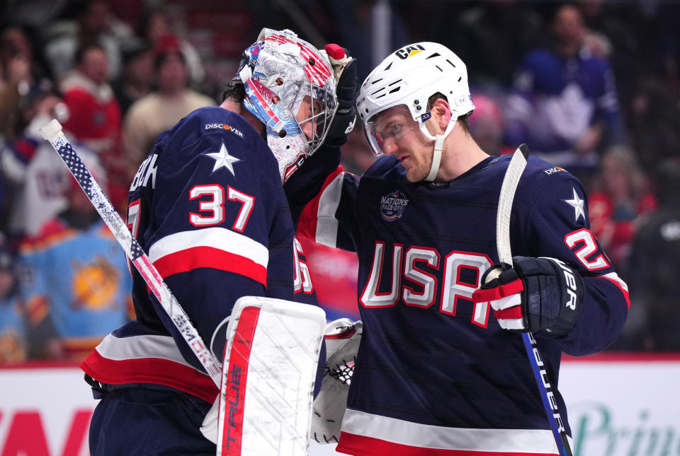 MONTREAL, QUEBEC - FEBRUARY 13: Connor Hellebuyck #37 of Team United States is congratulated by Adam Fox #23 after their 6-1 win in the 4 Nations Face-Off game between the United States and Finland at Bell Centre on February 13, 2025 in Montreal, Quebec. (Photo by Andrea Cardin/4NFO/World Cup of Hockey via Getty Images)