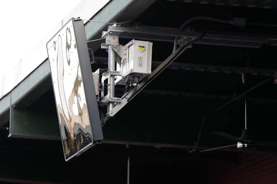 A radar device is seen on the roof behind home plate at PeoplesBank Park during the third inning of an Atlantic League All-Star minor league baseball game in York, Pa. Baseball's top minor leagues are switching to a challenge system full-time for their test of robot umpires. Major League Baseball has been experimenting with the automated ball-strike system in the minor leagues since 2019.