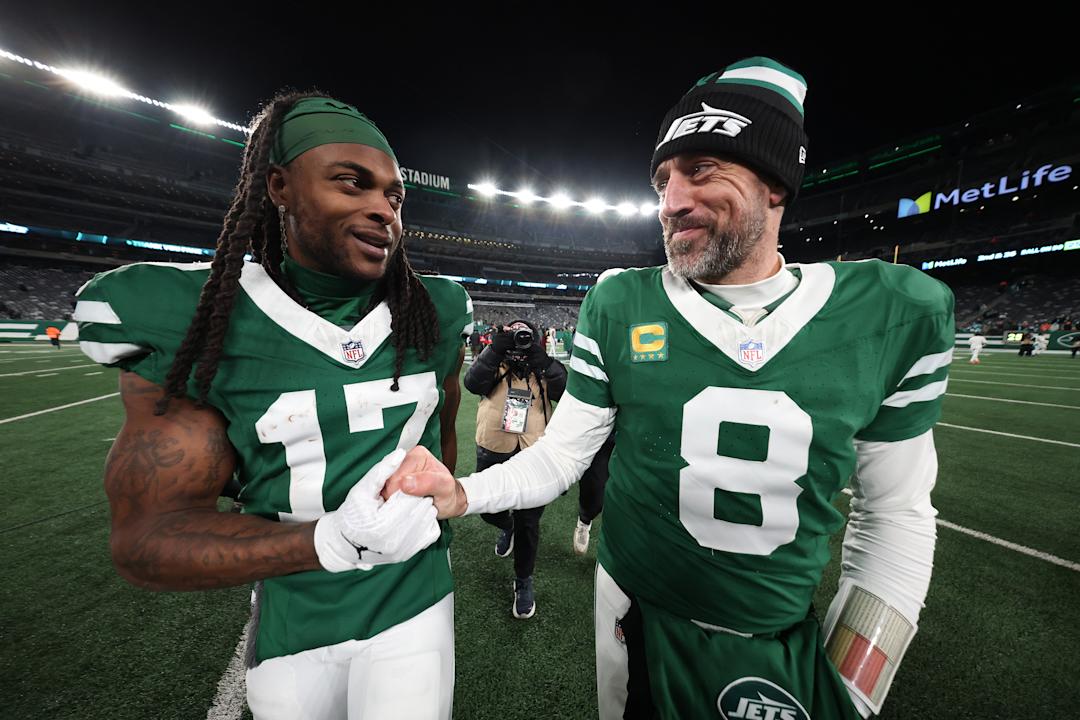 EAST RUTHERFORD, NEW JERSEY - JANUARY 05: Aaron Rodgers #8 and Davante Adams #17 of the New York Jets embrace after beating the Miami Dolphins 32-20 at MetLife Stadium on January 05, 2025 in East Rutherford, New Jersey.  (Photo by Al Bello/Getty Images)