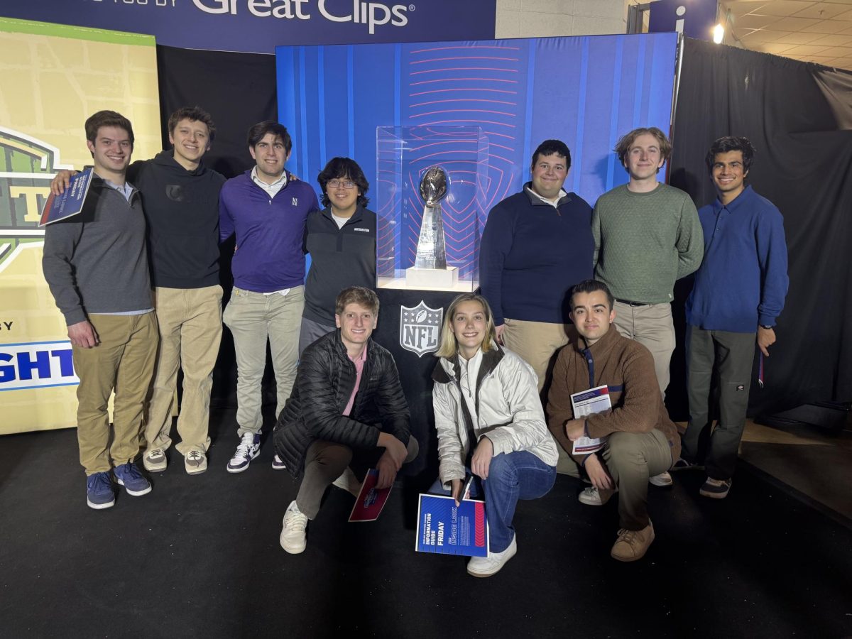 SMC members pose around the Lombardi Trophy.