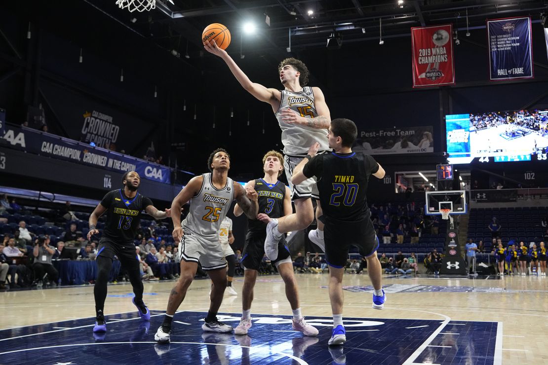 CAA conference player of the year Tyler Tejada takes it to the rim against Delaware Blue Hens guard Erik Timko (20) in the second half of the CAA Men's Basketball semifinal.