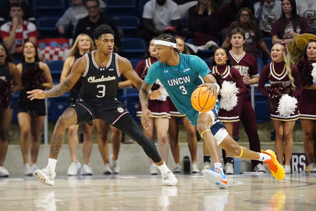 UNC-Wilmington Seahawks forward Sean Moore handles the ball against Charleston Cougars forward Elijah Jones (3) in the first half.