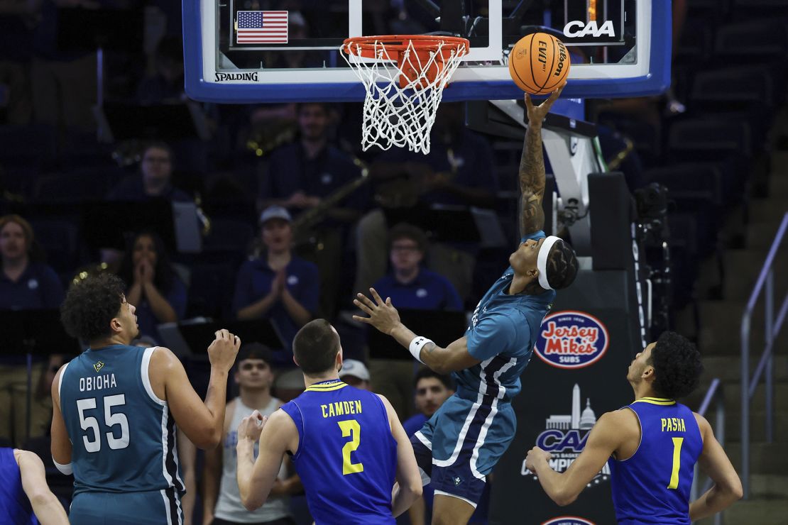 UNCW forward Sean Moore goes to the basket in the first half of the CAA championship.