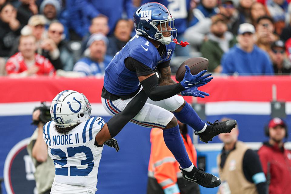 Dec 29, 2024; East Rutherford, New Jersey, USA; New York Giants wide receiver Malik Nabers (1) makes a catch as Indianapolis Colts cornerback Kenny Moore II (23) defends during the first half at MetLife Stadium. Mandatory Credit: Vincent Carchietta-Imagn Images