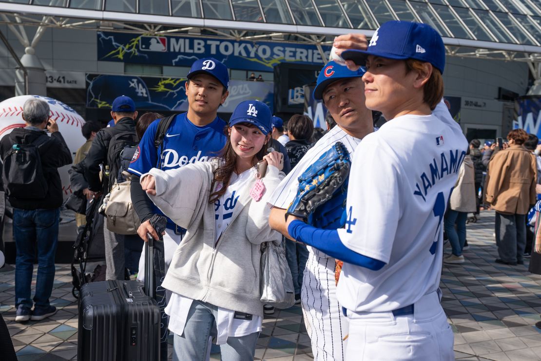 Fans pose for photos outside the stadium on Tuesday.