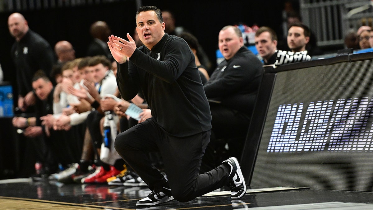 Sean Miller claps on court