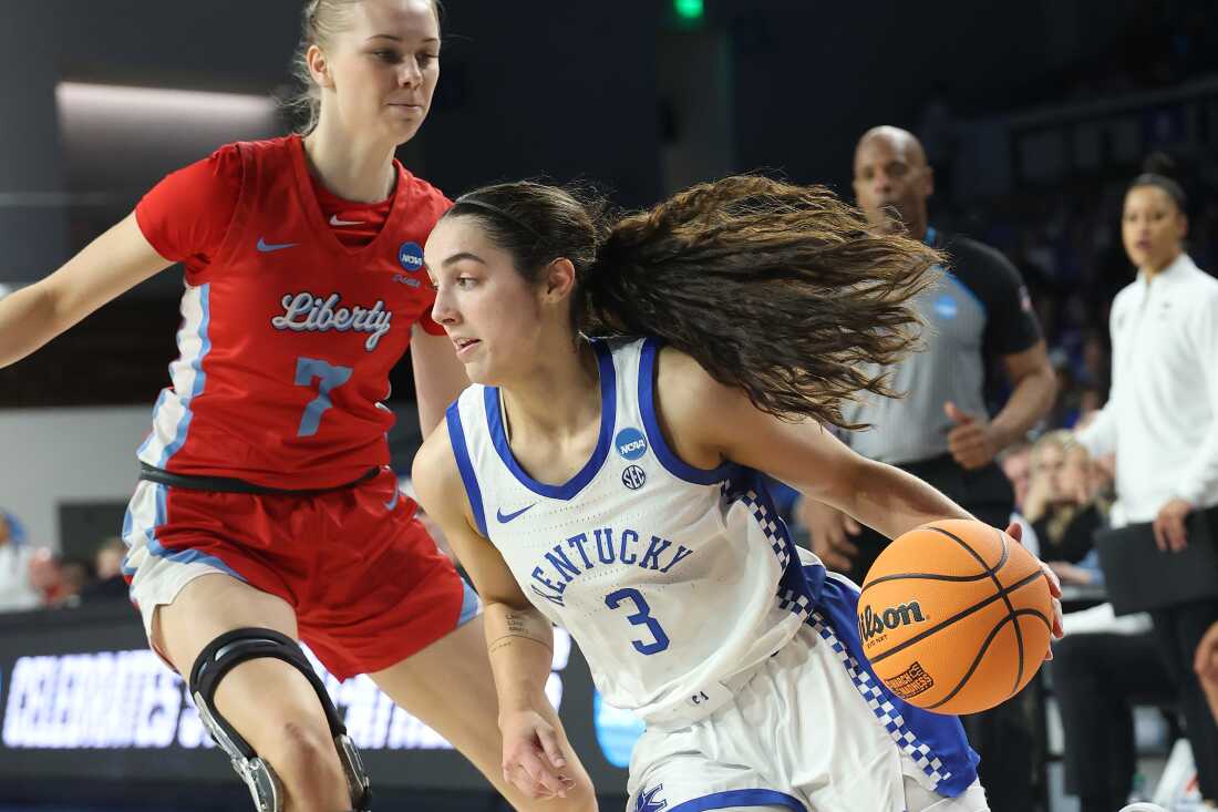 Georgia Amoore #3 of the Kentucky Wildcats drives around Pien Steenbergen #7 of the Liberty Lady Flames during the second half in the first round of the NCAA Women's Basketball Tournament on March 21, 2025 in Lexington, Kentucky.