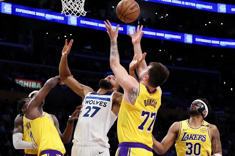 Luka Doncic and Timberwolves center Rudy Gobert battle for a rebound in the second quarter.