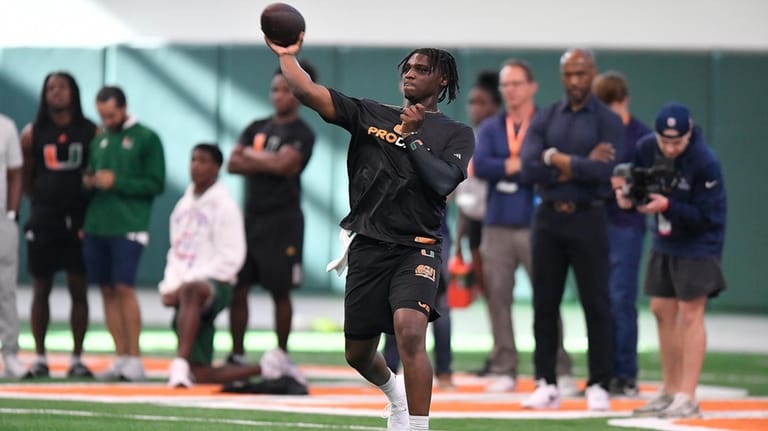 Miami quarterback Cam Ward throws during the school's NFL football...