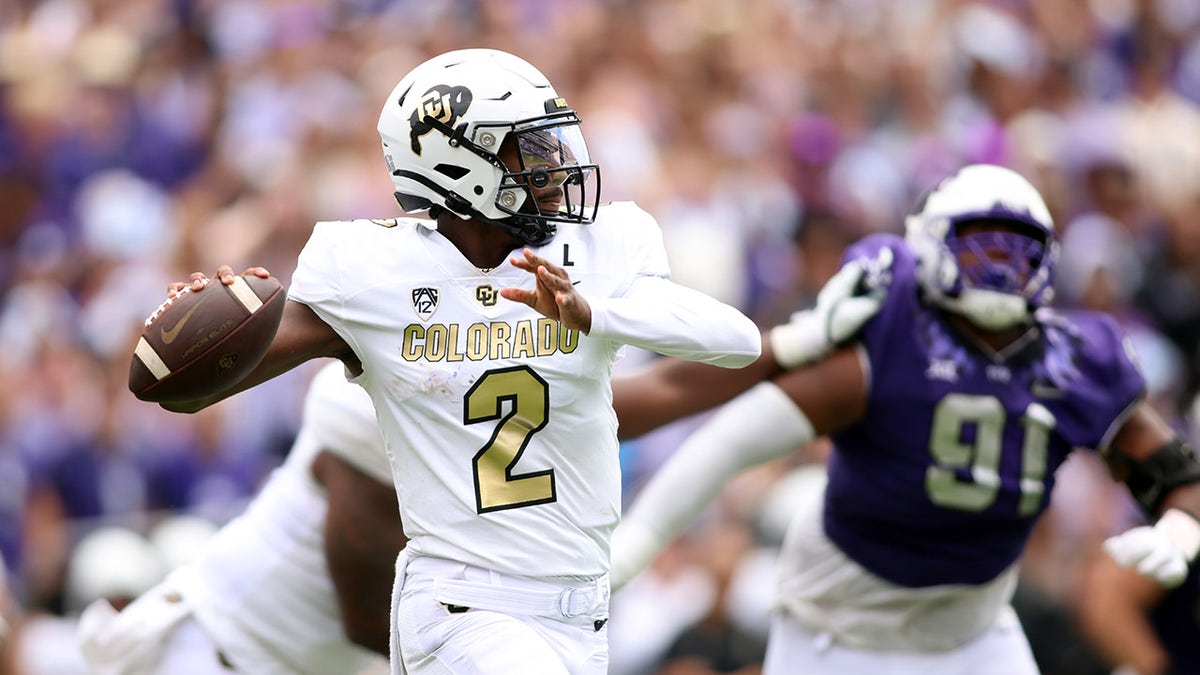 Shedeur Sanders getting ready to throw a football during a TCU football game